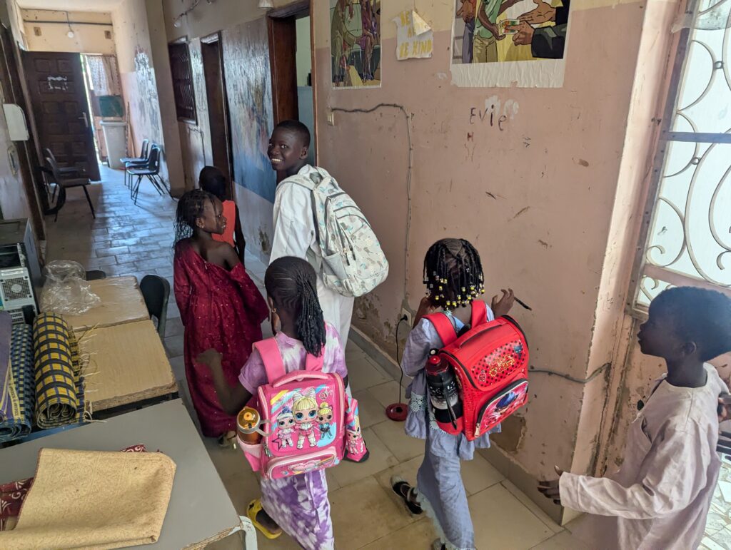 children arriving at the Diapalante Community Education Centre