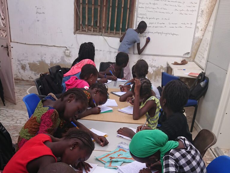 Learning together - older teenager teaching younger teenagers